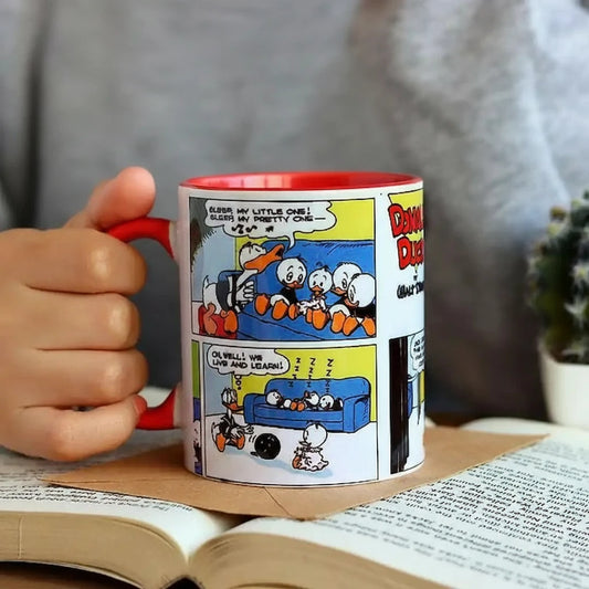 Graphic mug with Donald Duck design.