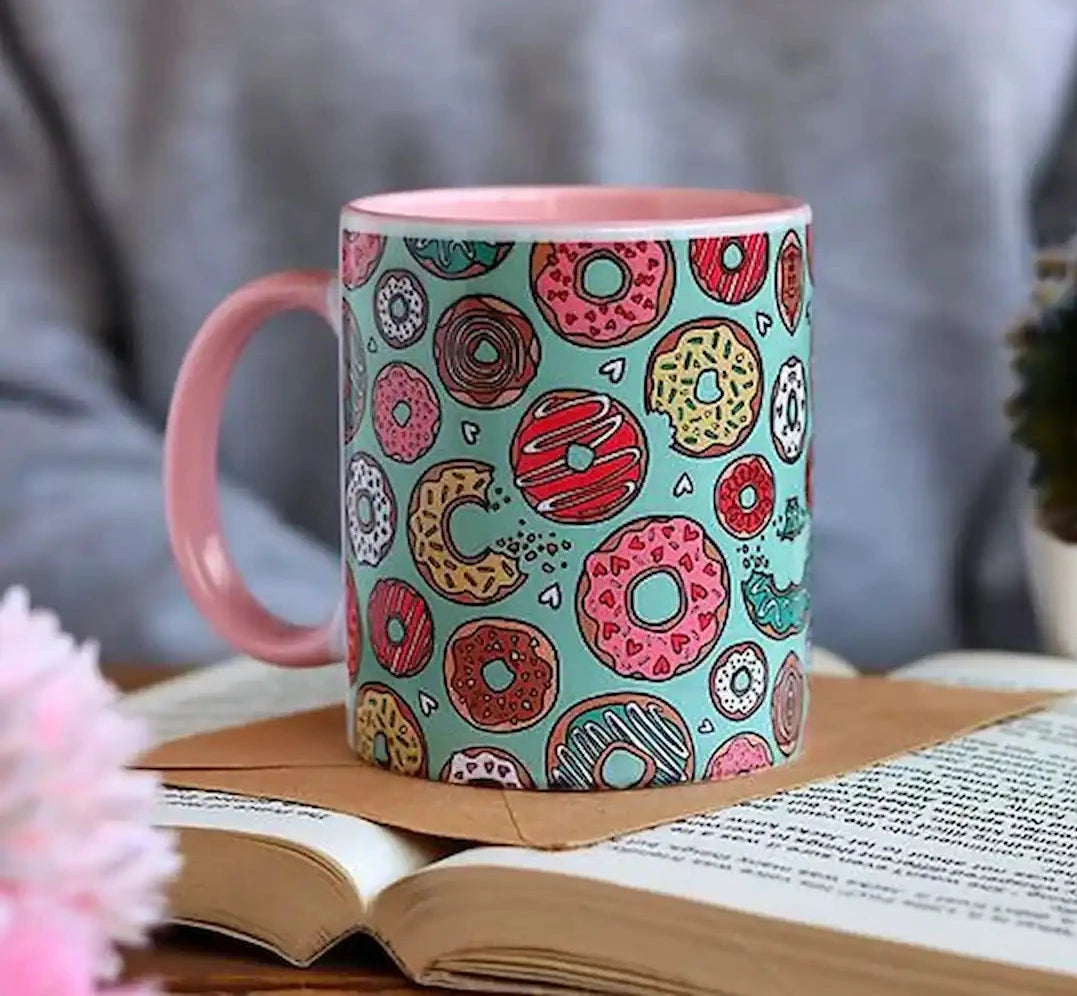 Graphic mug featuring doughnuts design.